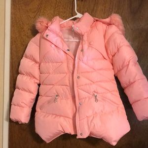 Pink puffer jacket with faux fur accent.
